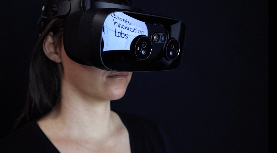 Woman wearing Varjo V3 VR headset with the Lowes Innovation Labs name in headset reflection. 